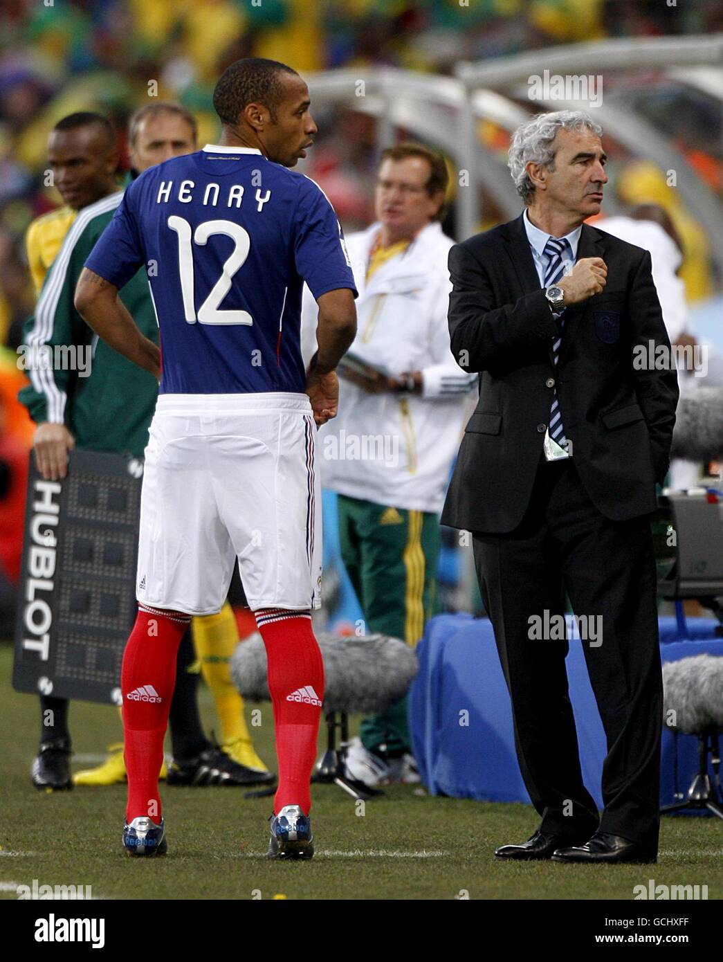 France's Thierry Henry (left) talks with coach Raymond Domenech (right) on the touchline Stock Photo