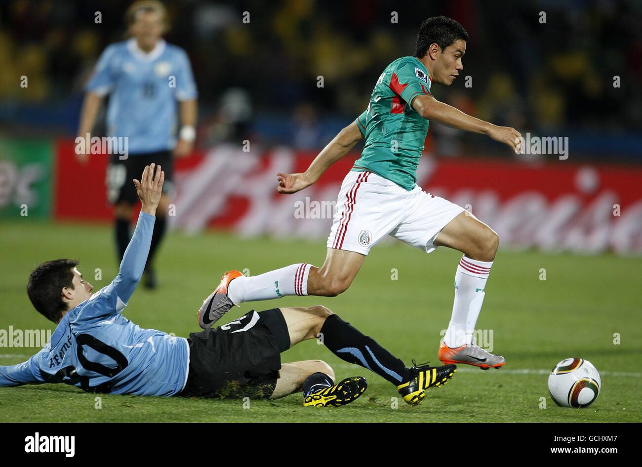 Mexico's Pablo Barrera (right) skips past the challenge of Uruguay's Alvaro Fernandez Stock Photo