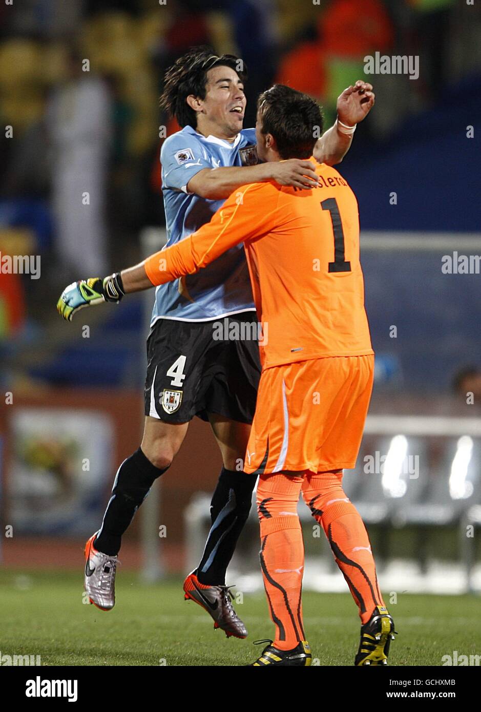 Uruguay's Jorge Fucile (left) celebrates victory with goalkeeper Nestor Fernando Muslera after the final whistle Stock Photo
