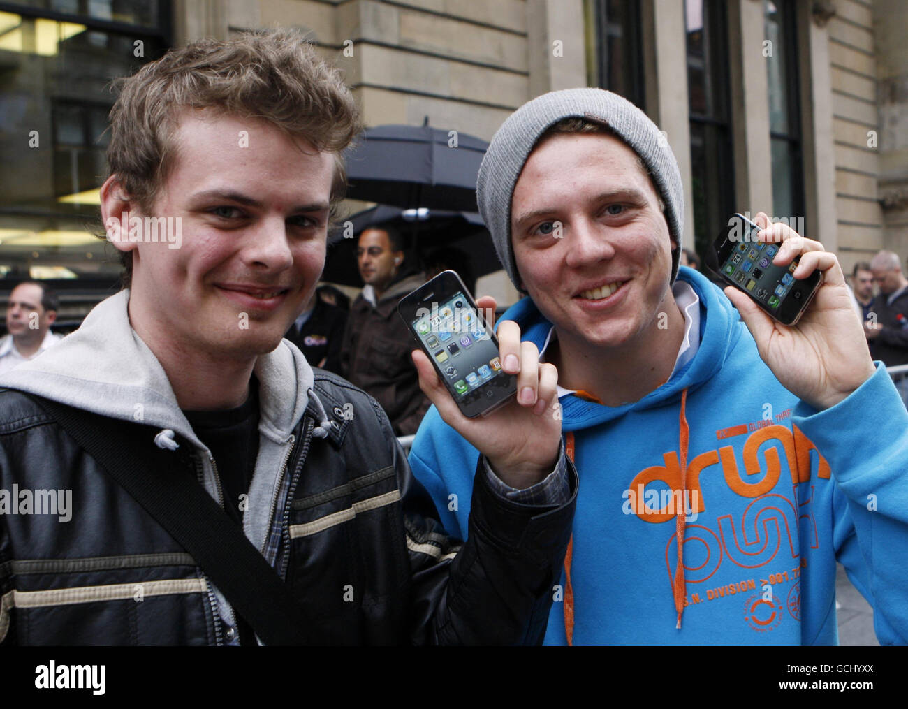 William Shaw (left) and David Polmie with their new iPhones outside the Apple store on Buchanan Street in Glasgow as the iPhone 4 goes on sale across the UK. Stock Photo