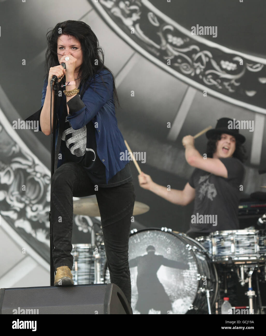 The Dead Weather lead singer Alison Mosshart, with Jack White on drums in the background as their band The Dead Weather perform on the Pyramid stage on the second day of music at Glastonbury Worthy Farm, Somerset. Stock Photo