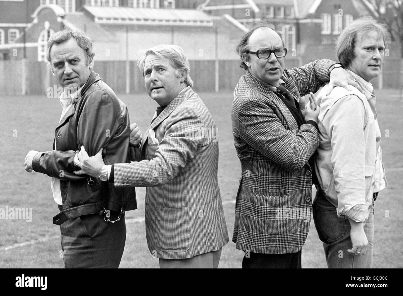 Comedians Eric Morecambe and Ernie Wise in the Hammersmith grounds of Euston Films today, where they teamed up with tough crimebusters Carter and Regan of 'The Sweeney' Fame. Inspector Regan, actor John Thaw (left) and Det Sgt Carter, actor Dennis Waterman appeared as gusts on a Morecambe and Wise Christmas show in 1976. They joked they would only appear if Eric and Ernie agreed to appear in their show, and now the quartet will play in The Sweeney: 'Hearts and Minds' an episode of the next series on ITV. Stock Photo