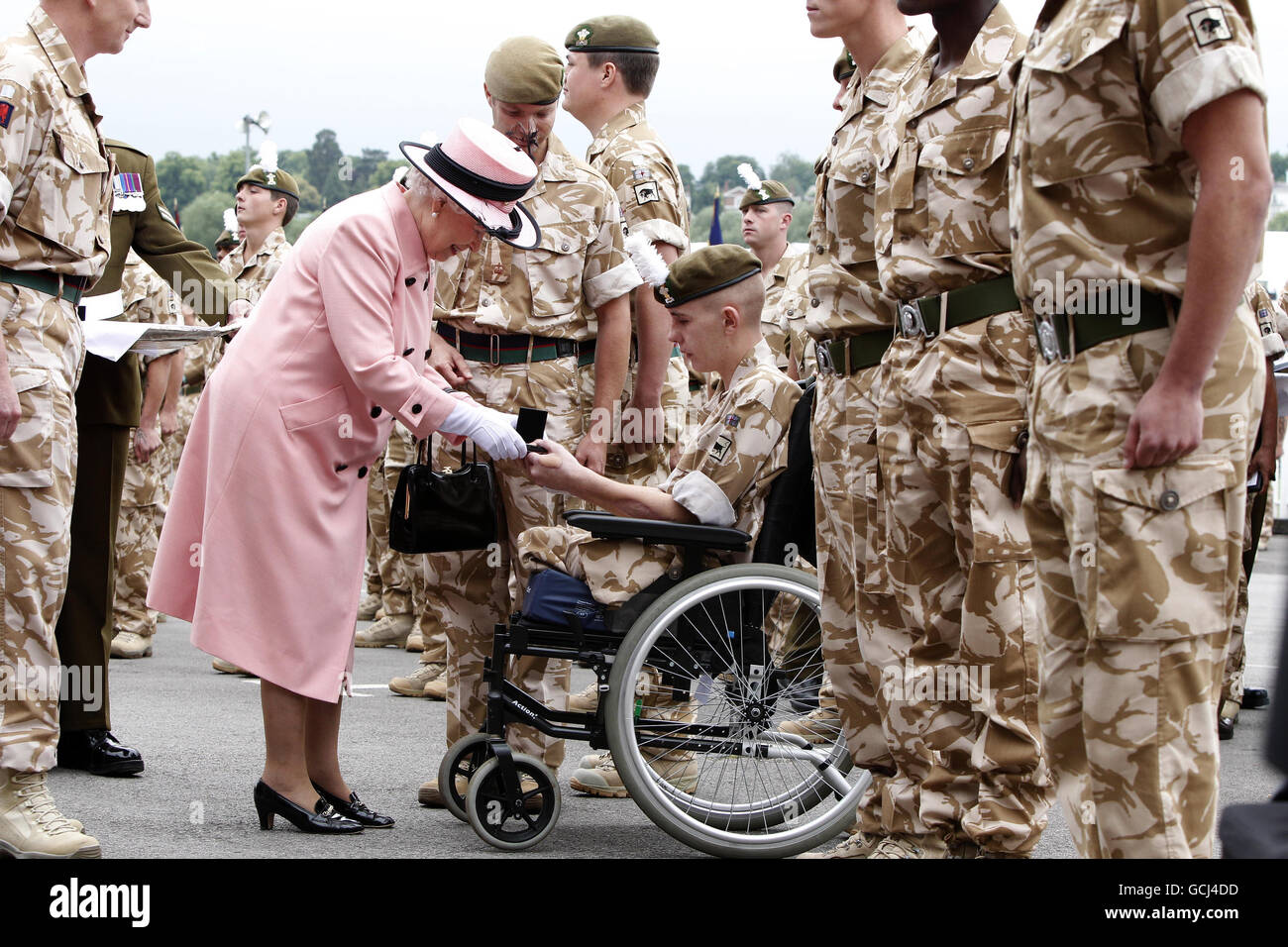 Britain's Queen Elizabeth II presents a Campaign Medal to Shaun Stocker, 19, from Wrexham of 1st Battalion Royal Welsh, during the Drumhead Service of Thanksgiving to mark the return of 1st Battalion Royal Welsh from operations in Afghanistan, at Chester Racecourse, Chester. Stock Photo