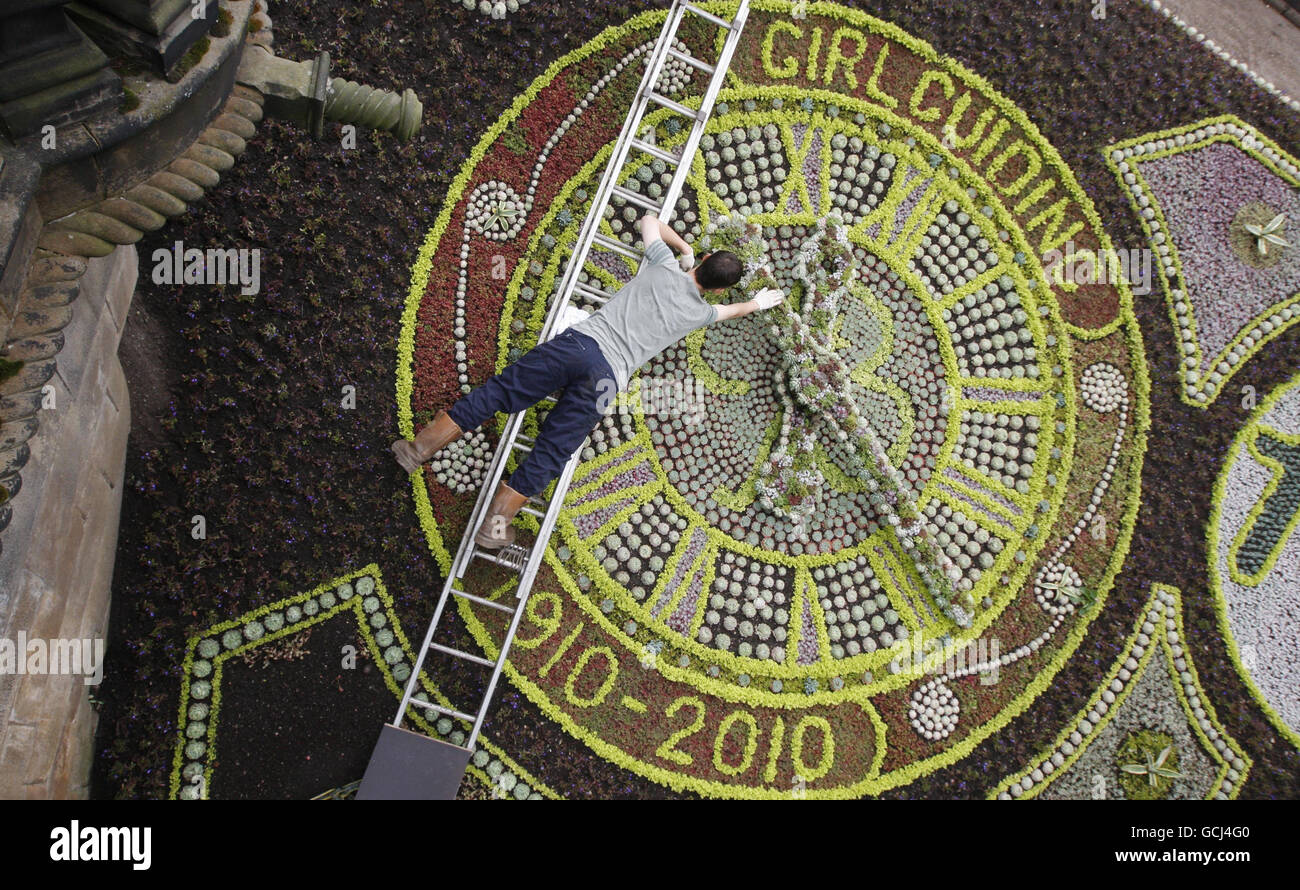 A gardener puts the finishing touches to the Floral Clock in Princes Street Gardens in Edinburgh. Stock Photo