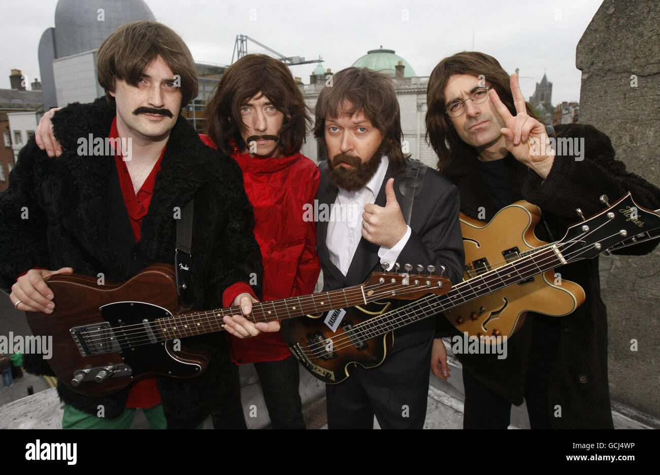 (Left to right) Rob McKinny as George Harrison, Binder as Ringo Starr, Fran King as Paul McCartney and Scott Maher as John Lennon, the cast of 'Get Back - The Story of The Beatles' perform on the roof of Dublin's Olympia Theatre to promote their show which runs from Wednesday 4th August until Sunday 8th August. Stock Photo