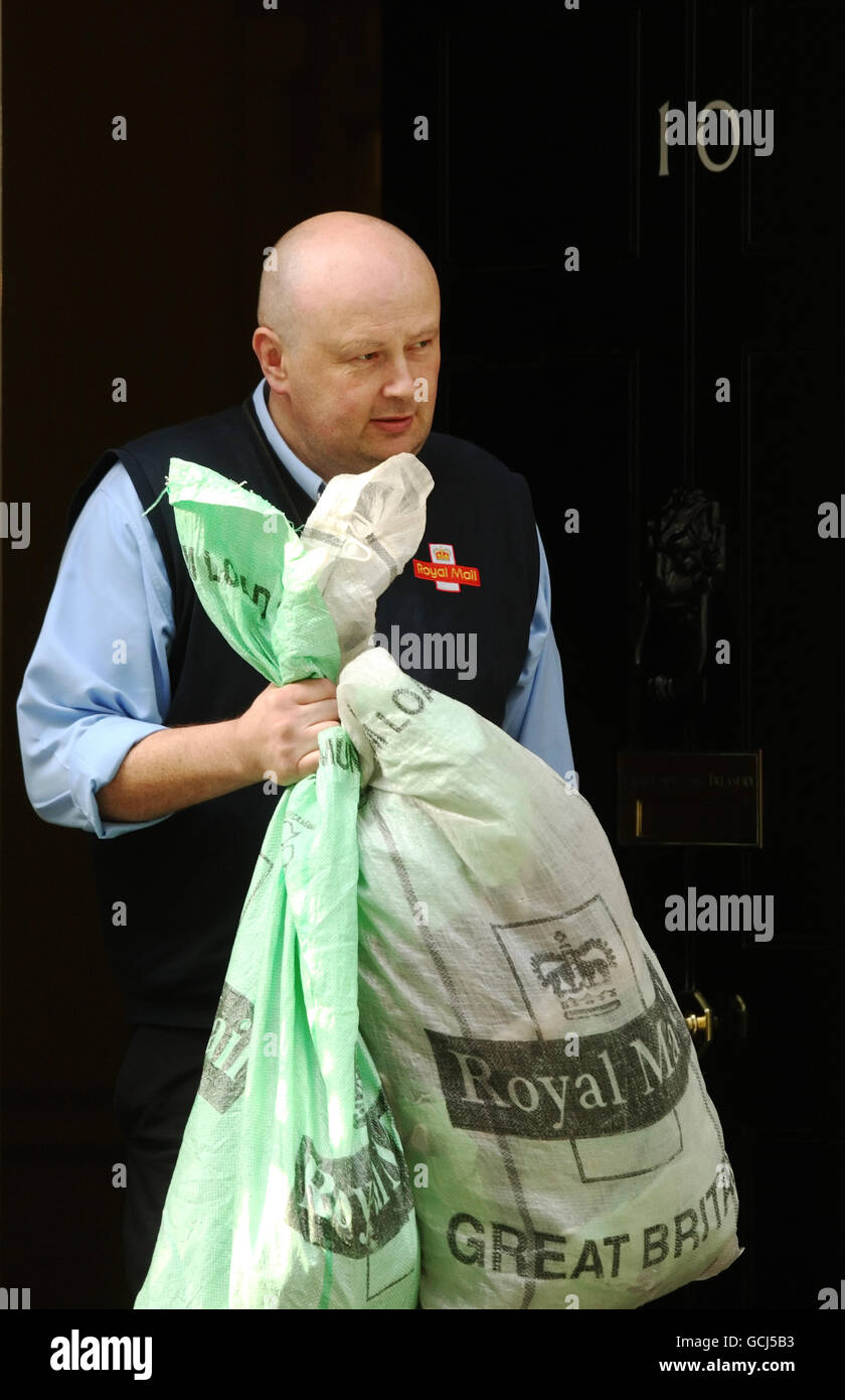 Postman carrying royal mail delivery bags leaves 10 downing street hi