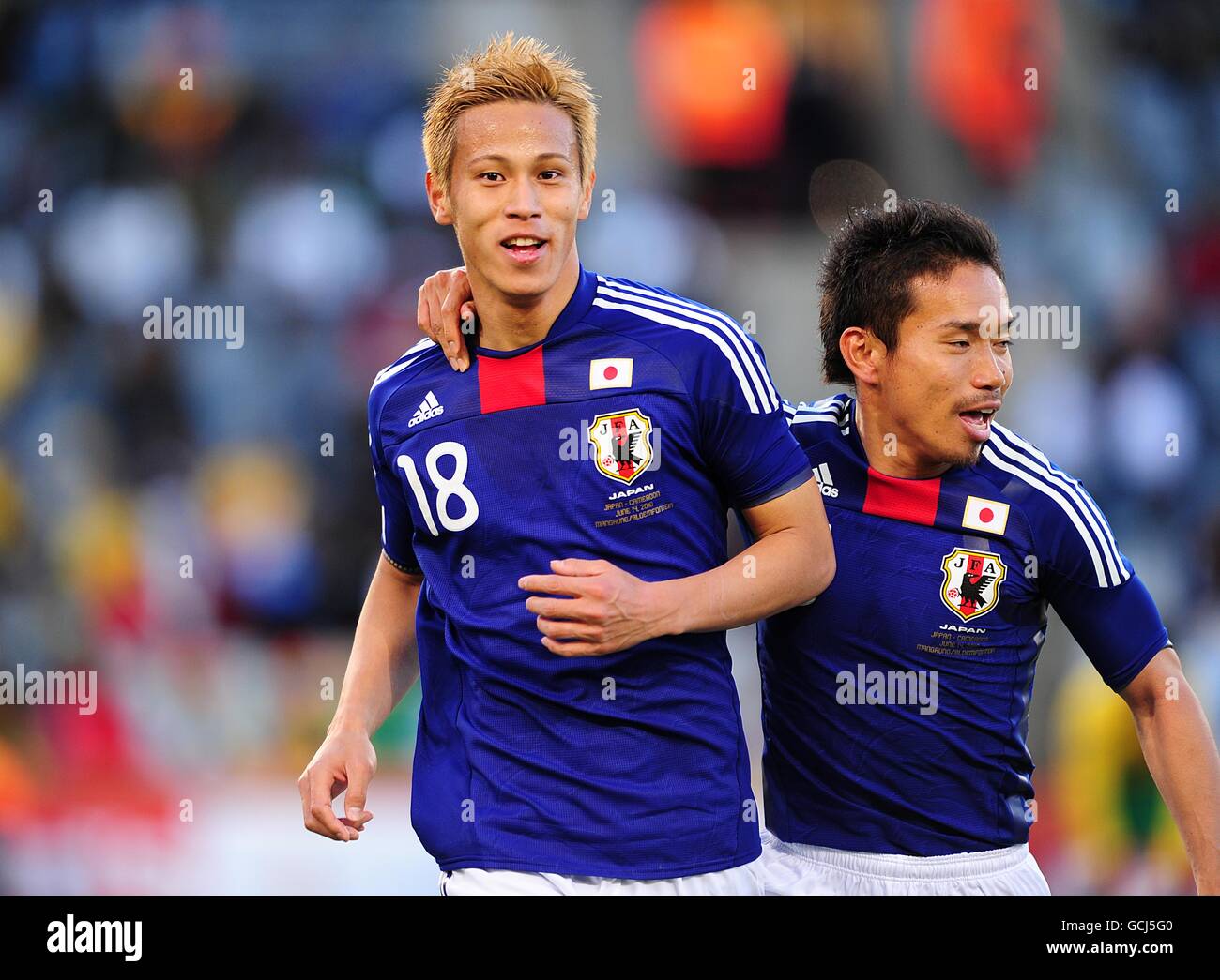 Soccer - 2010 FIFA World Cup South Africa - Group E - Japan v Cameroon - Free State Stadium. Japan's Keisuke Honda (left) celebrates with team mate Yuto Nagatomo (right) after scoring the first goal of the game Stock Photo