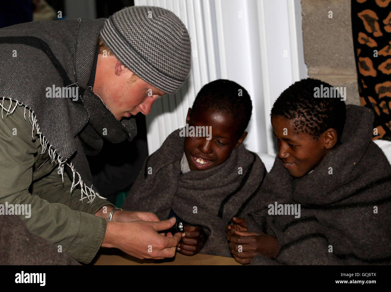 SEMONKONG, LESOTHO - JUNE 16: Prince Harry meets children at St Leonard's Herd Boy School on June 16, 2010 in Semonkong, Lesotho. The two Princes are on a joint trip to Africa which takes in Botswana, Lesotho and finally South Africa. During that time they will visit a number of projects supported by their respective charities Sentebale (Prince Harry) and Tusk Trust (Prince William). The trip will culminate with the brothers watching the England vs Algeria World Cup match in Cape Town. Stock Photo