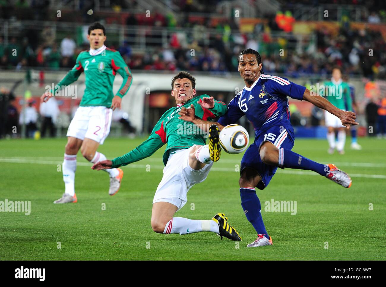 France's Florent Malouda (right) and Mexico's Hector Moreno, (left) battle for the ball. Stock Photo