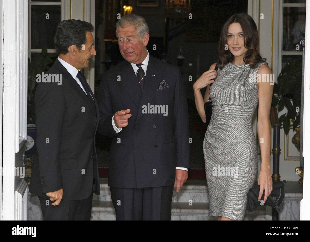 The Prince of Wales greets the French President Nicolas Sarkozy, and his wife Carla Bruni at Clarence House, London during the President's visit to mark the 70th anniversary of General Charles de Gaulle's radio broadcast urging his nation to resist the Nazi occupation of France. Stock Photo