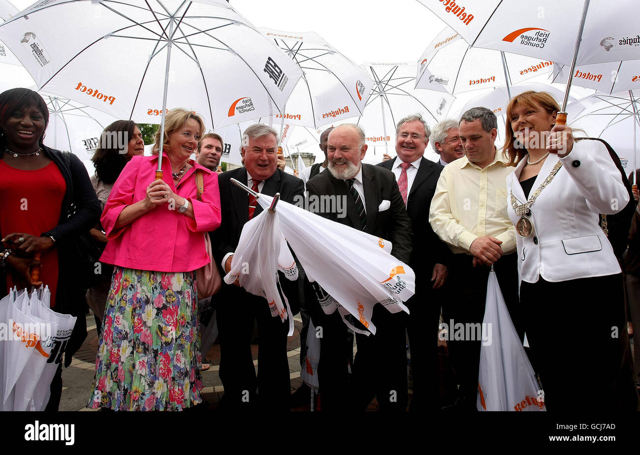 Senator David Norris (centre left) and Senator Terry Leyden (centre right) duel with umbrellas, watched by Dublin Lord Mayor Emer Costello (right) under umbrellas at an event held by the Irish Refugee Council on Grafton Street, Dublin, to mark World Refugee Day. Stock Photo