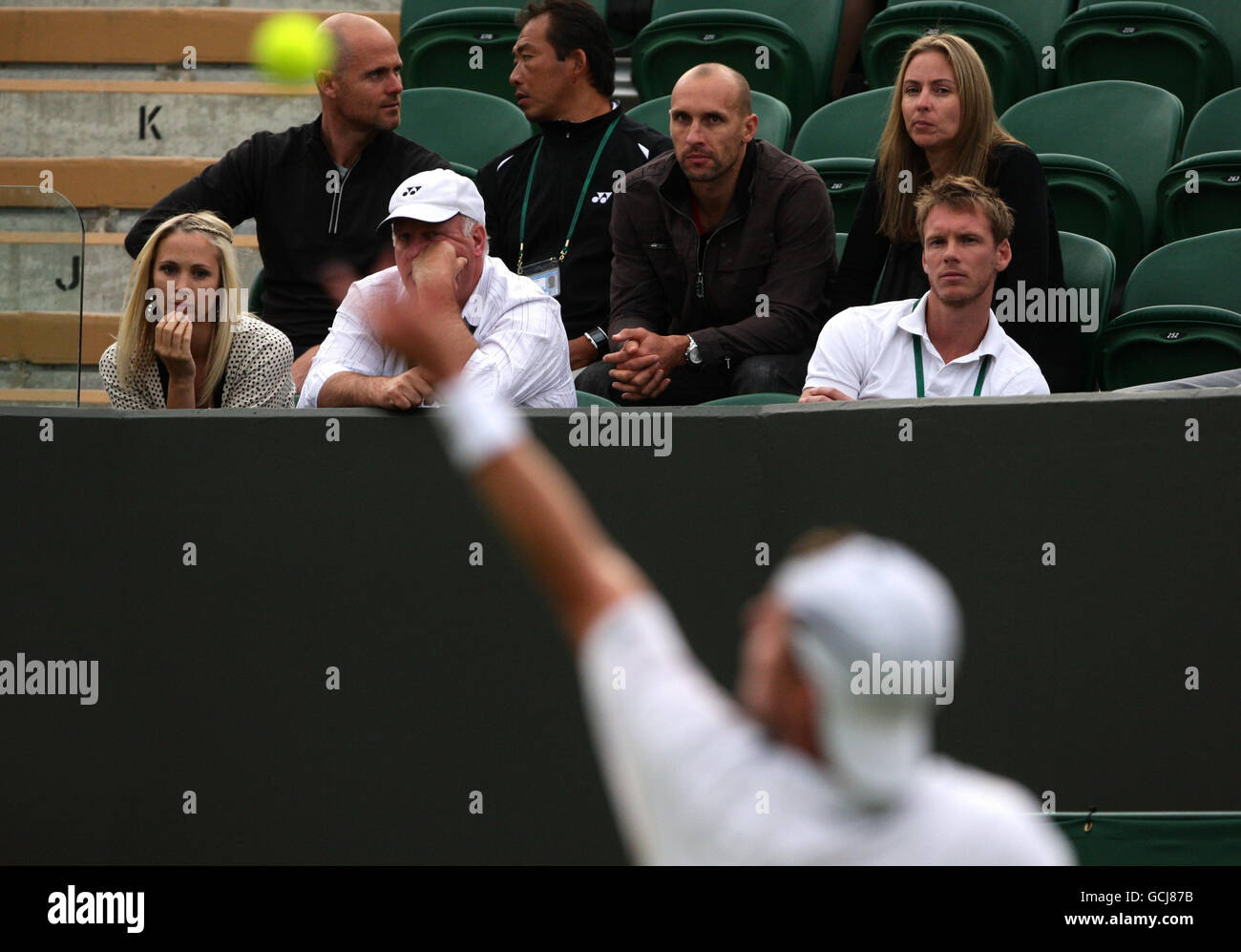 Bec Cartwright (left) watches her husband Lleyton Hewitt in action against Argentina's Maximo Gonzalez during Day One of the 2010 Wimbledon Championships at the All England Lawn Tennis Club, Wimbledon. Stock Photo