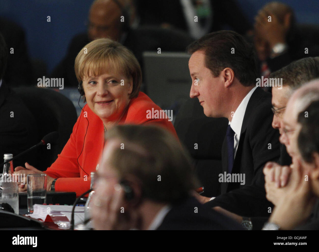 Prime Minister David Cameron, (right), Germany's Chancellor Angela Merkel, (left), attend the opening session of the G20 nations summit in Toronto, Canada. Stock Photo