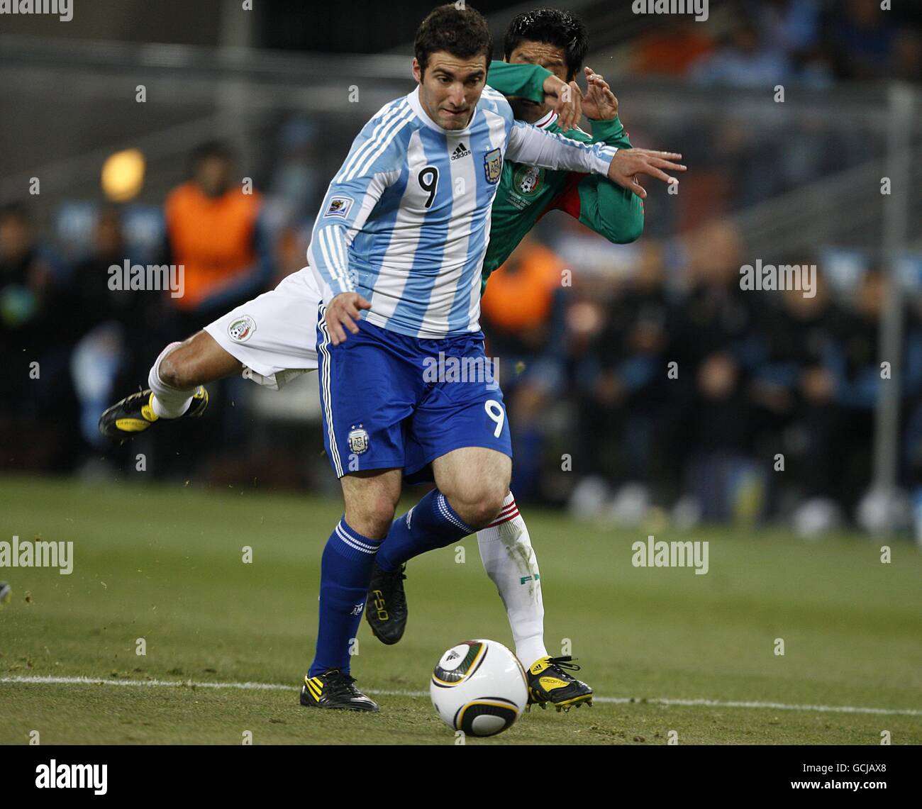 Argentina's Gonzalo Higuain holds off Mexico's Ricardo Osorio before scoring his sides second goal Stock Photo