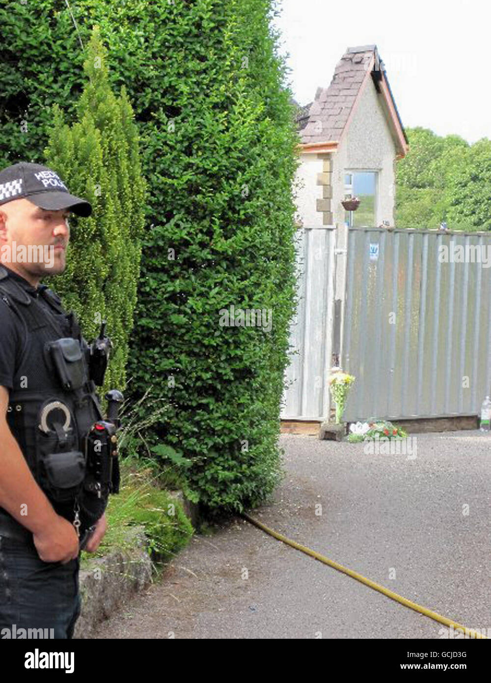 A general view of police at the scene in Anglesey, where Heather Bickley, 46, and sons Oscar, 6, and Felix, 10, were found dead after a fire broke out in their home. Stock Photo