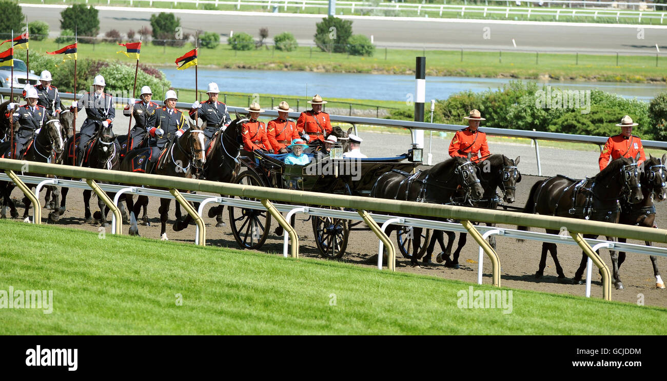 Britain's Queen Elizabeth II and the Duke of Edinburgh ride in an open