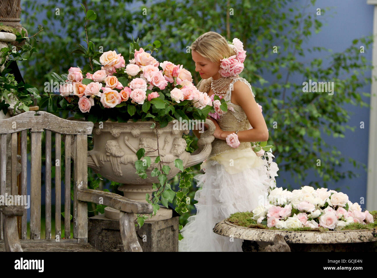 Model Flora Neville poses for photographers on the Country Roses stand at the Hampton Court Palace flower show, London. Stock Photo