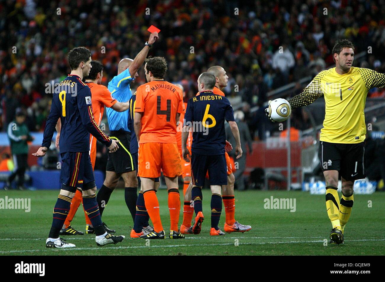 Soccer - 2010 FIFA World Cup South Africa - Final - Netherlands v Spain - Soccer City Stadium. Netherlands' Johnny Heitinga (right) is shown the red card by referee Howard Webb after fouling Spain's Andres Iniesta (6) Stock Photo