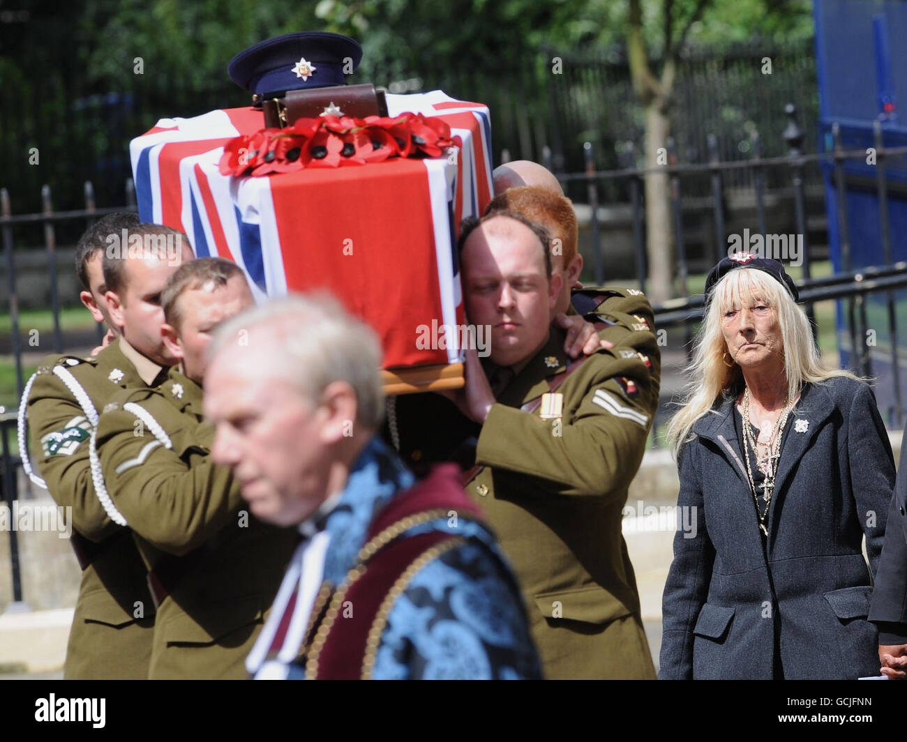 Soldiers from the Royal Dragoon Guards carry the coffin of Trooper Ashley Smith, 21, as his mother Sandra Smith (right), wearing the regiment beret of the Royal Dragoon Guards follows on, at his funeral in York Minster. Stock Photo