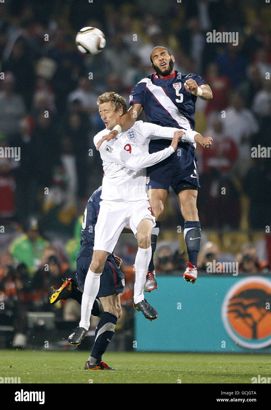 Soccer - 2010 FIFA World Cup South Africa - Group C - England v USA - Royal Bafokeng Stadium. USA's Oguchi Onyewu (right) and England's Peter Crouch (left) battle for the ball Stock Photo