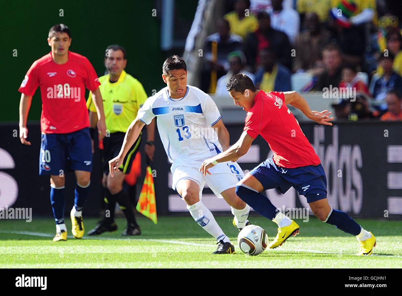 Honduras' Roger Espinoza (left) and Chile's Alexis Sanchez (right) battle for the ball. Stock Photo