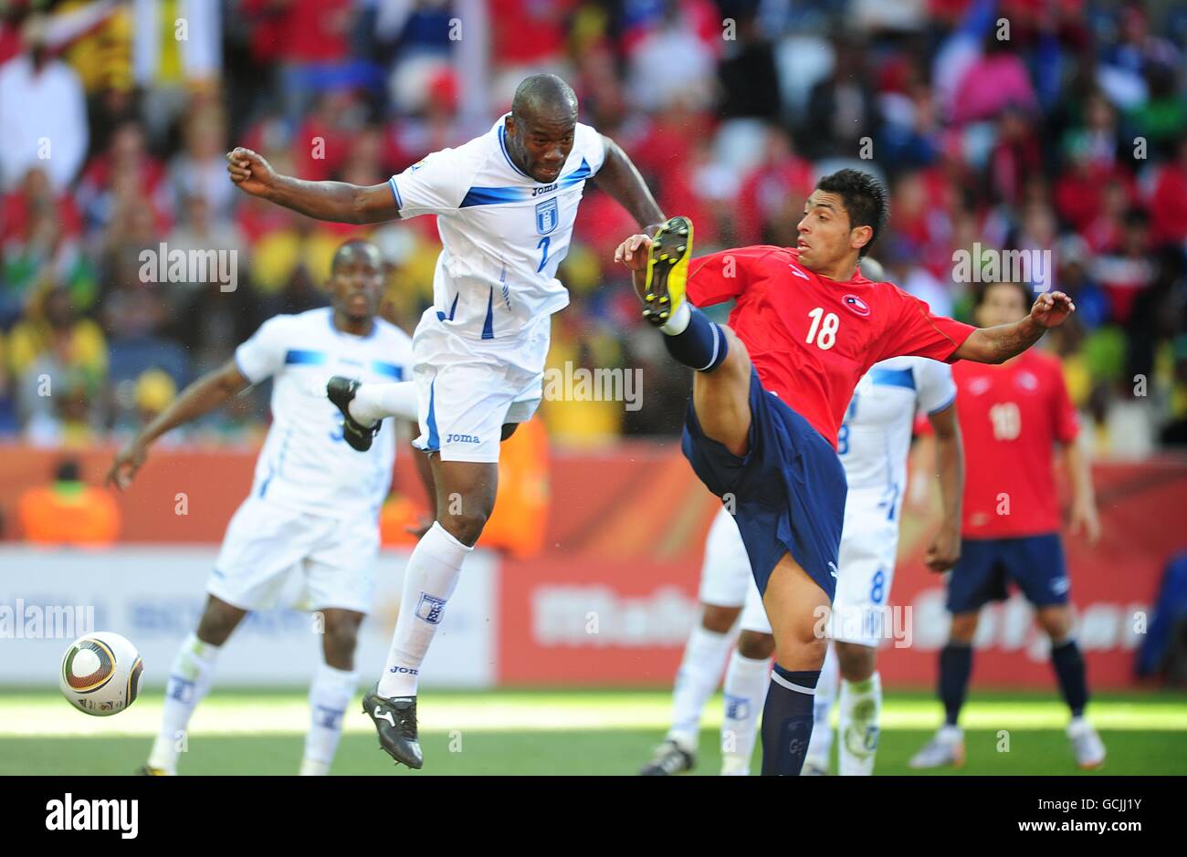 Chile's Gonzalo Jara (right) and Honduras' Ramon Nunez (left) battle for the ball. Stock Photo