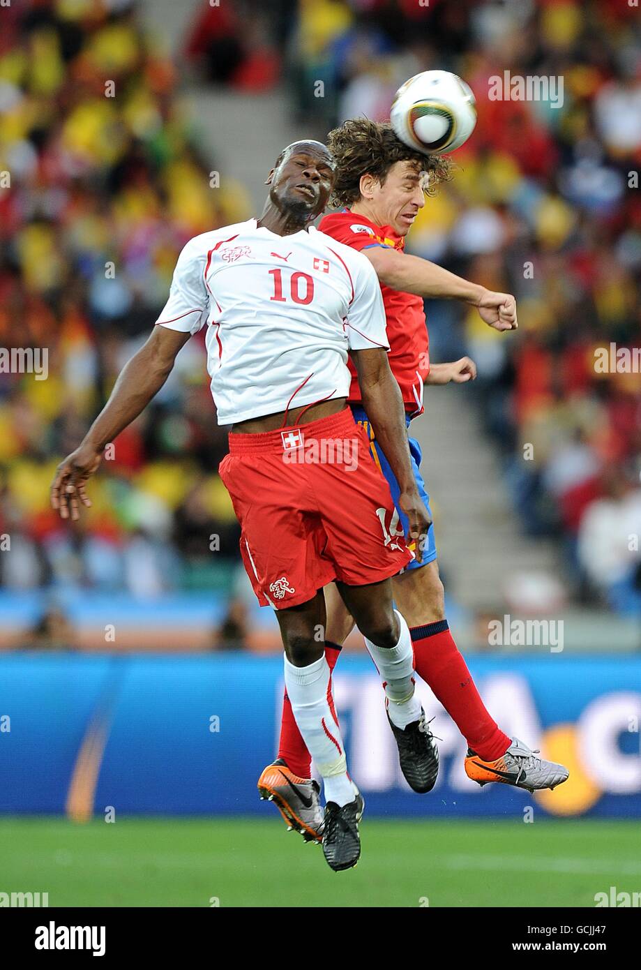 Soccer - 2010 FIFA World Cup South Africa - Group H - Switzerland v Spain - Durban Stadium. Switzerland's Blaise Nkufo (left) and Spain's Carles Puyol battle for the ball Stock Photo