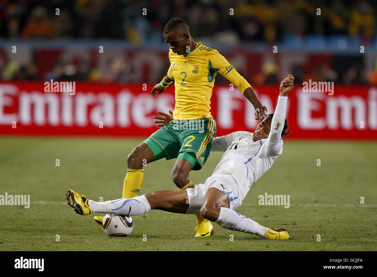 Soccer - 2010 FIFA World Cup South Africa - Group A - South Africa v Uruguay - Loftus Versfeld Stadium. South Africa's Siboniso Gaxa (left) is challenged by Uruguay's Alvaro Pereira (right) for the ball Stock Photo