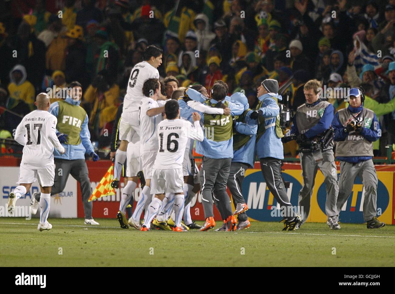 Uruguay's Alvaro Pereira (hidden) is congratulated by his team mates after scoring the third goal Stock Photo