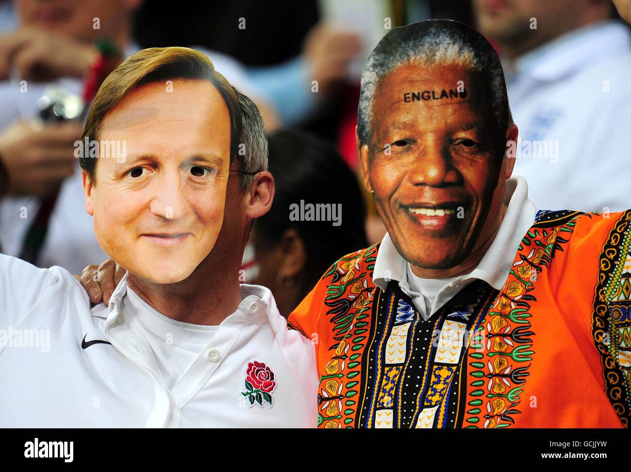 Soccer - 2010 FIFA World Cup South Africa - Group C - England v Algeria - Green Point Stadium. England fans wearing masks of David Cameron and Nelson Mandela, in the stands prior to kick off Stock Photo
