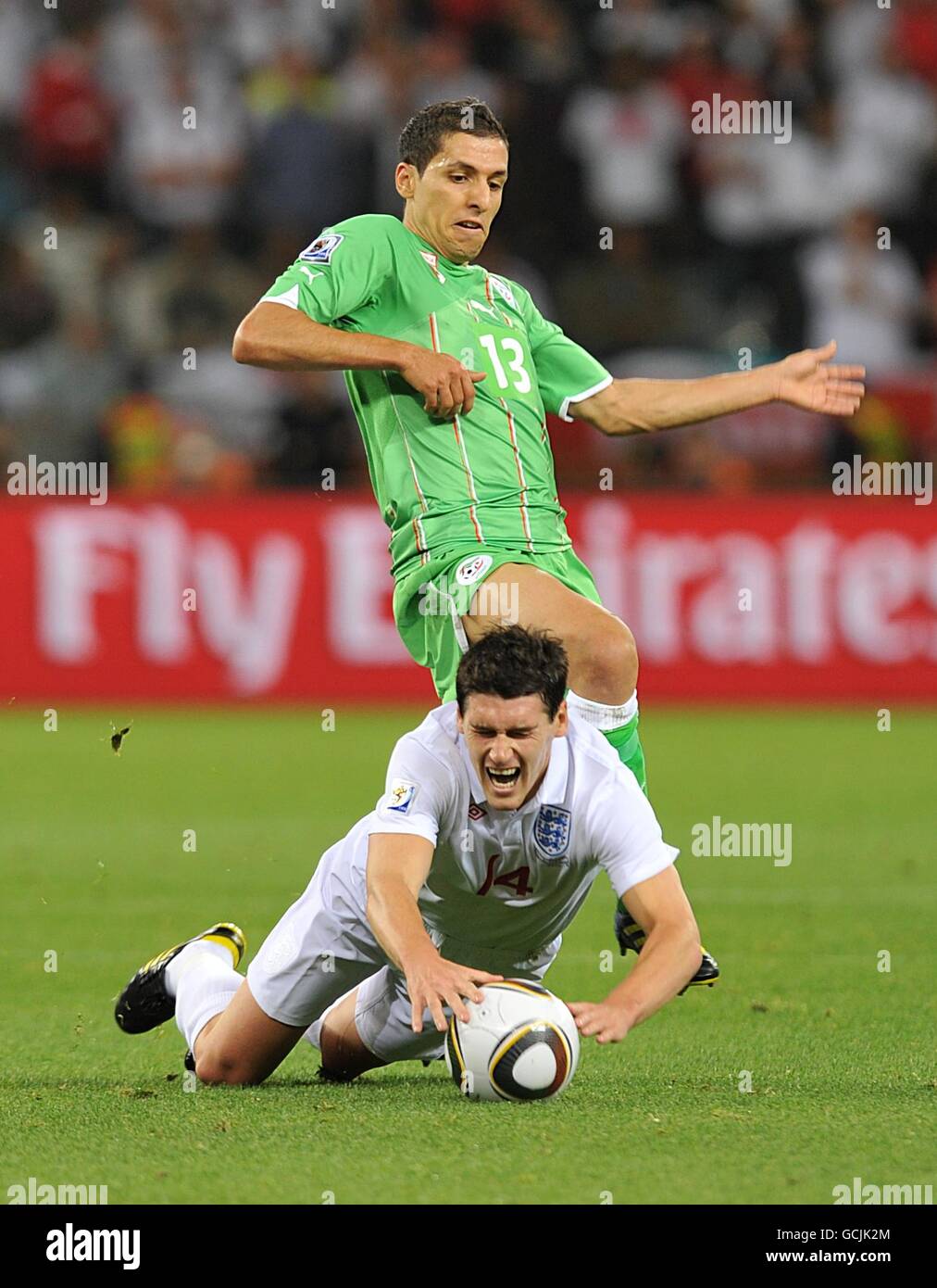 England's Gareth Barry is fouled by Algeria's Karim Matmour Stock Photo