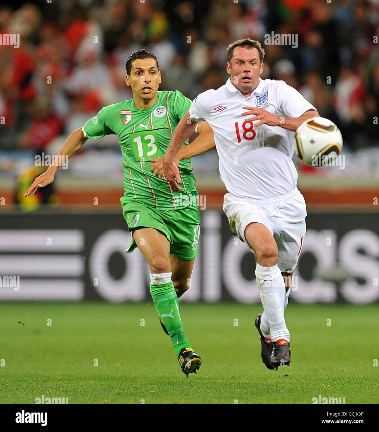 Soccer - 2010 FIFA World Cup South Africa - Group C - England v Algeria - Green Point Stadium. England's Jamie Carragher (right) gets away from Algeria's Karim Matmour Stock Photo