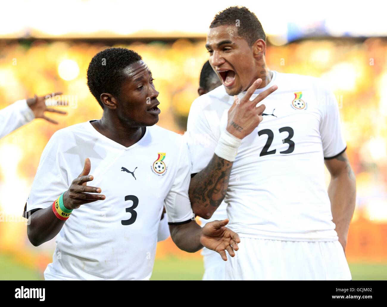 Soccer - 2010 FIFA World Cup South Africa - Group D - Ghana v Australia - Royal Bafokeng Stadium. Ghana's Asamoah Gyan (left) celebrates scoring his sides first goal of the game with Kevin-Prince Boateng Stock Photo