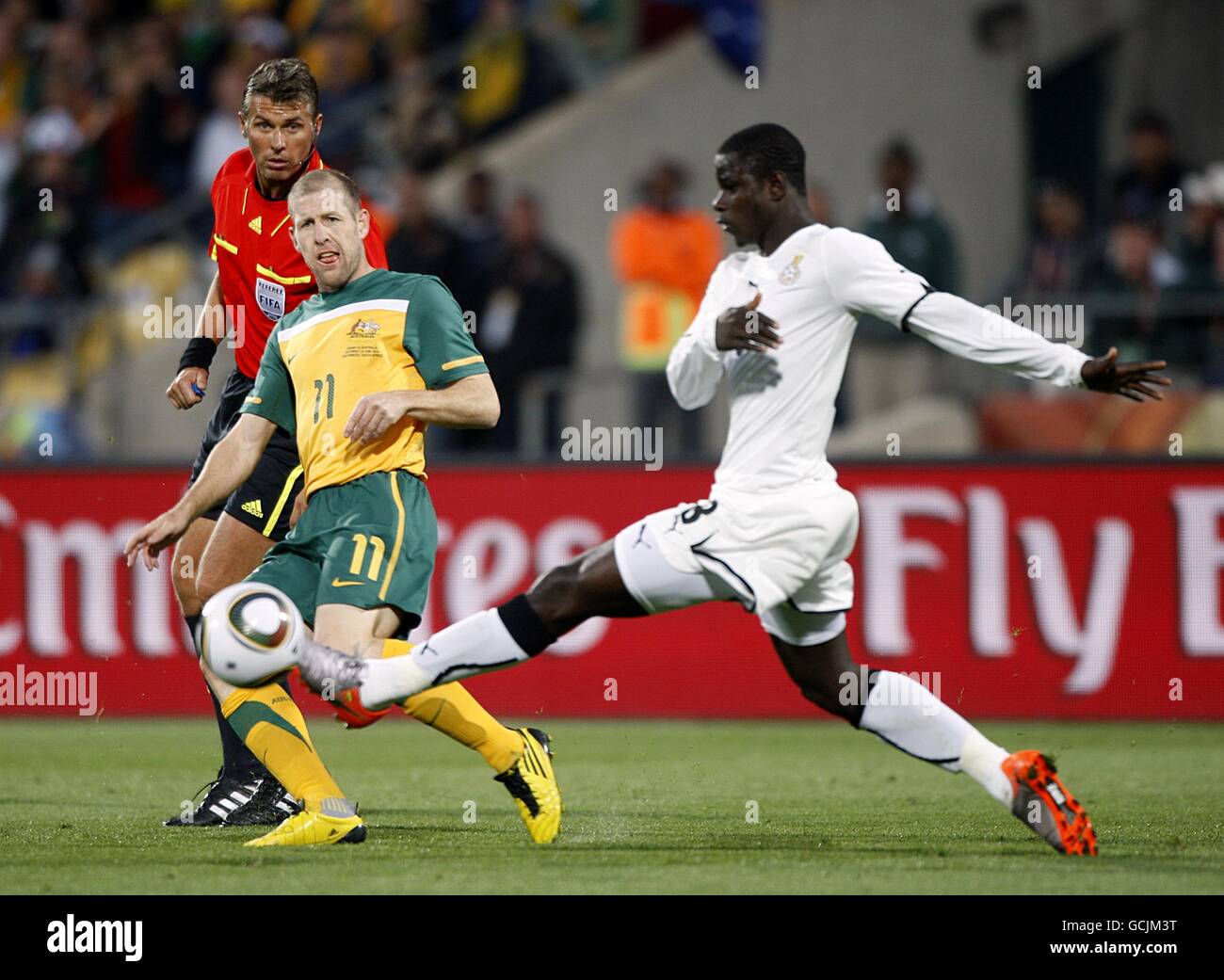 Australia's Scott Chipperfield (left) and Ghana's Jonathan Mensah battle for the ball Stock Photo