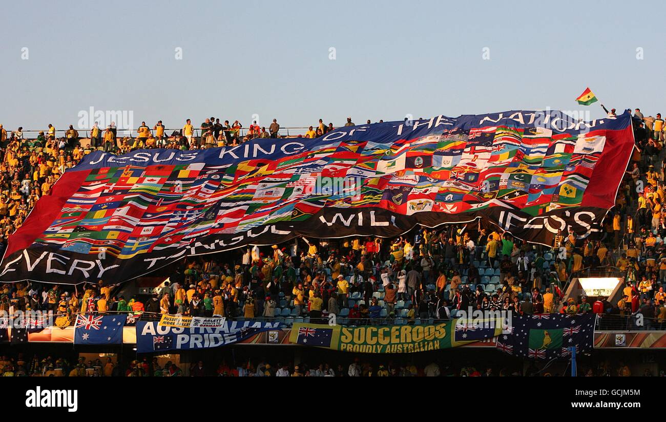 Soccer - 2010 FIFA World Cup South Africa - Group D - Ghana v Australia - Royal Bafokeng Stadium. Fans in the stands display a huge banner saying Jesus King of Nations Every Tongue will confess in the stands Stock Photo