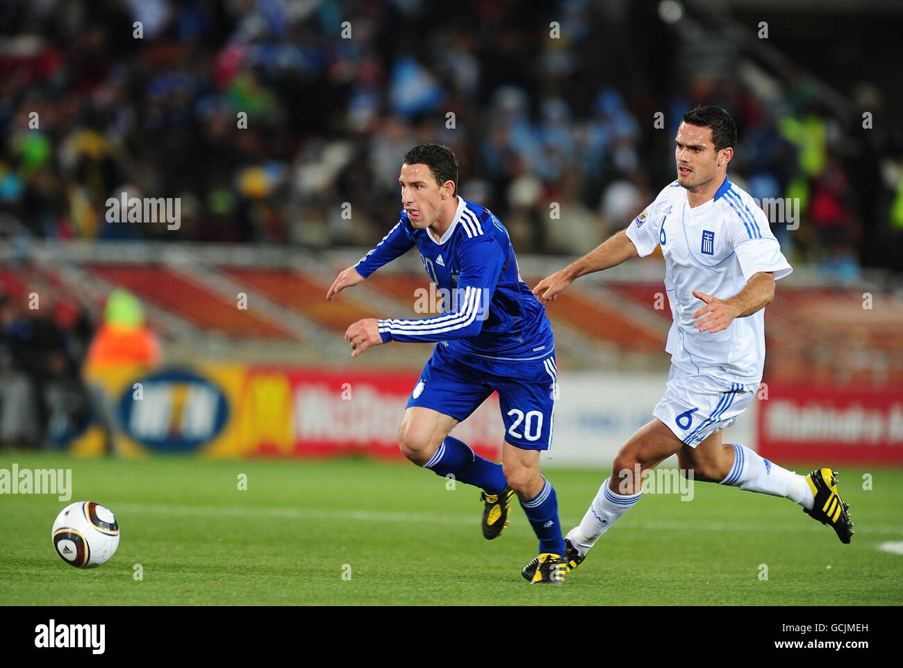 Soccer - 2010 FIFA World Cup South Africa - Group B - Greece v Argentina - Peter Mokaba. Greece's Alexandros Tzorvas (right) and Argentina's Rodriguez Maxi (left) battle for the ball. Stock Photo