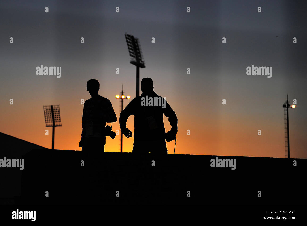 A silohette of a pair of photograpers on the Peter Mokaba Stadium Stock Photo