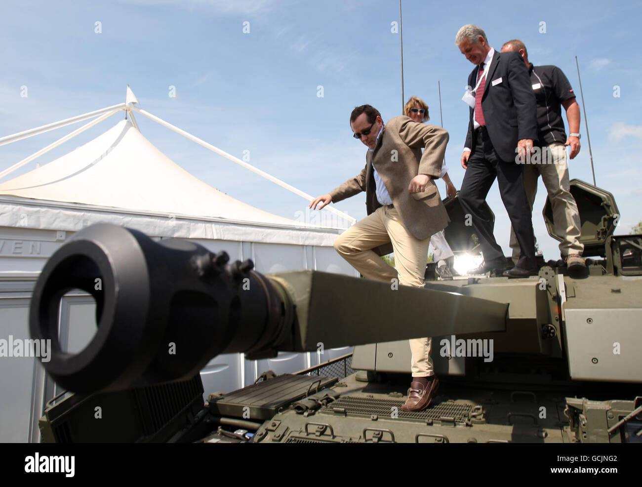 Peter Luff, Minister for Defence Equipment, Support and Technology, climbs out of a Warrior Tank during Defence Vehicle Dynamic (DVD) 2010, a showcase of military equipment at the Millbrook Proving Ground in Bedfordshire. Stock Photo