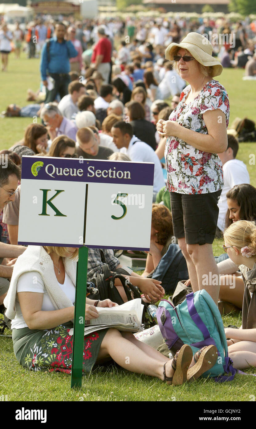 People queue in Wimbledon Park, in south west London, as they wait for tickets for the Wimbledon Tennis Championships at the All England Lawn Tennis Club. Stock Photo