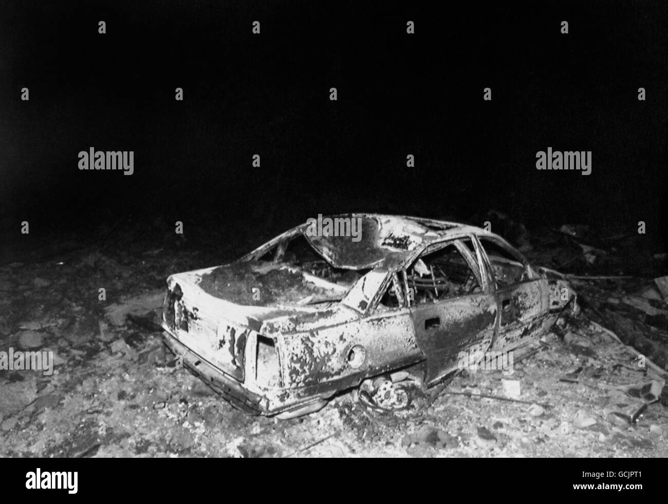 A burnt out car at the garage hit by wreckage from the Pan Am Boeing flight PA 103 which crashed at Lockerbie. The crash killed all 258 on board and 17 people on the ground. Stock Photo