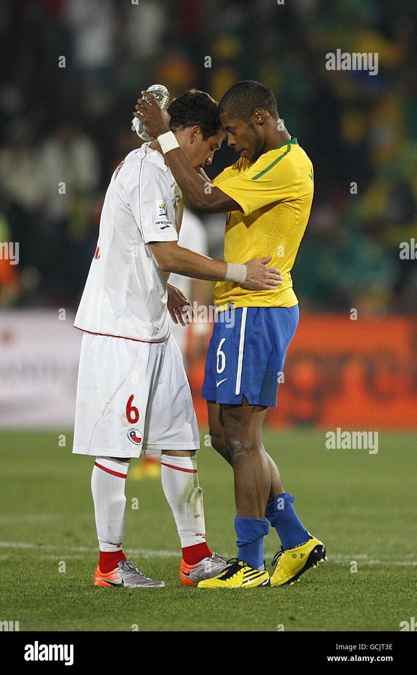 Soccer - 2010 FIFA World Cup South Africa - Round Of 16 - Brazil v Chile - Ellis Park. Brazil's Fernandes Michel Bastos (right) comforts Chile's Carlos Carmona (left) after the final whistle. Stock Photo
