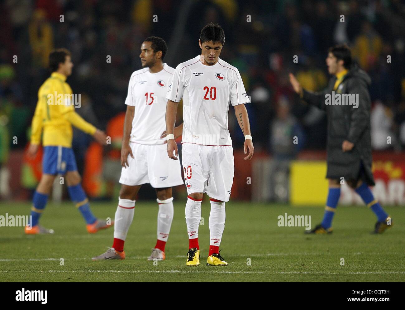 Chile's Jean Beausejour (centre left) and Rodrigo Millar (centre right) appear dejected whilst Brazilian players celebrate after the final whistle. Stock Photo