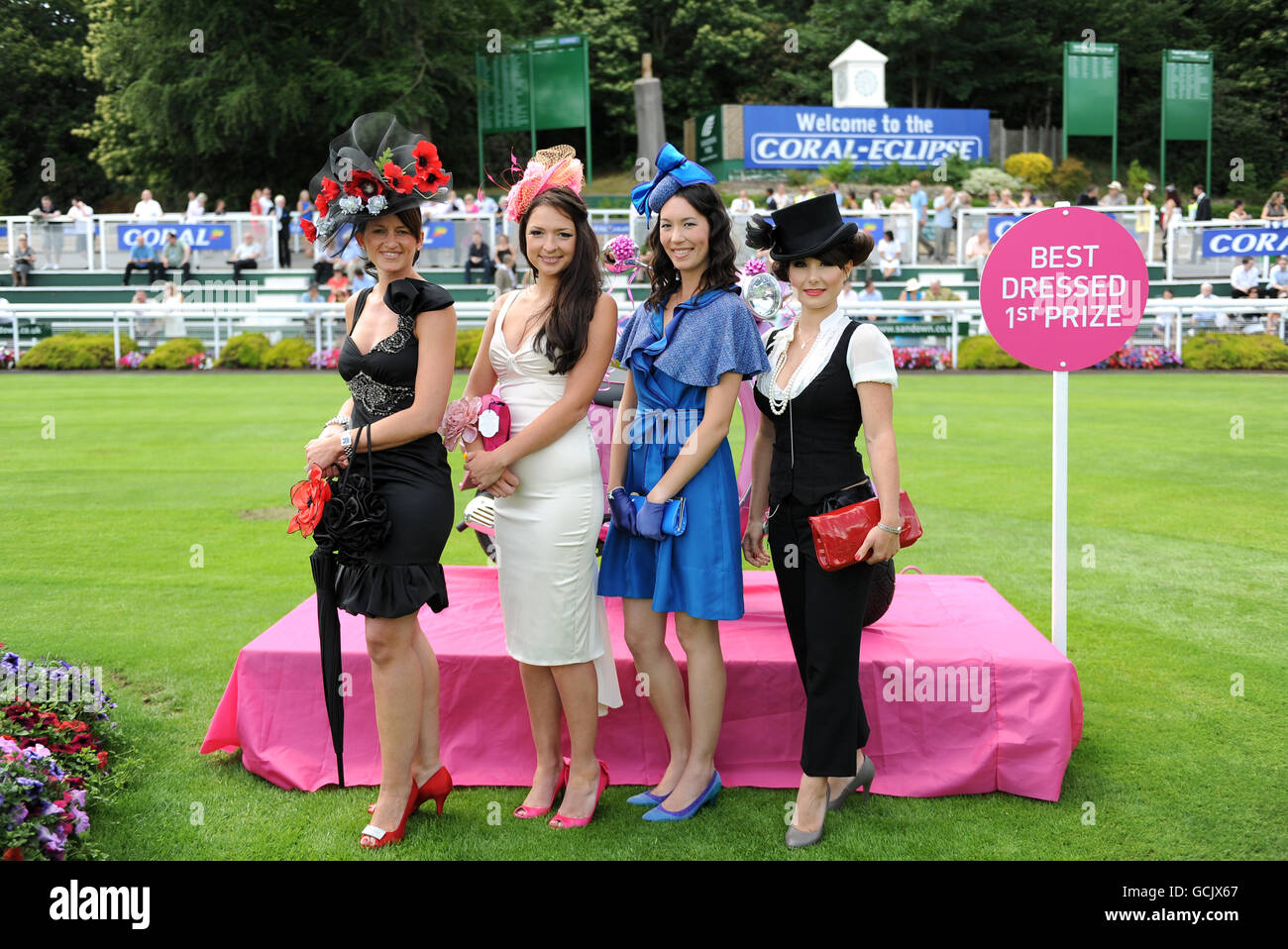 Racegoers take part in the Best Dressed Lady competition during the Coral-Eclipse Day at Sandown Park Stock Photo