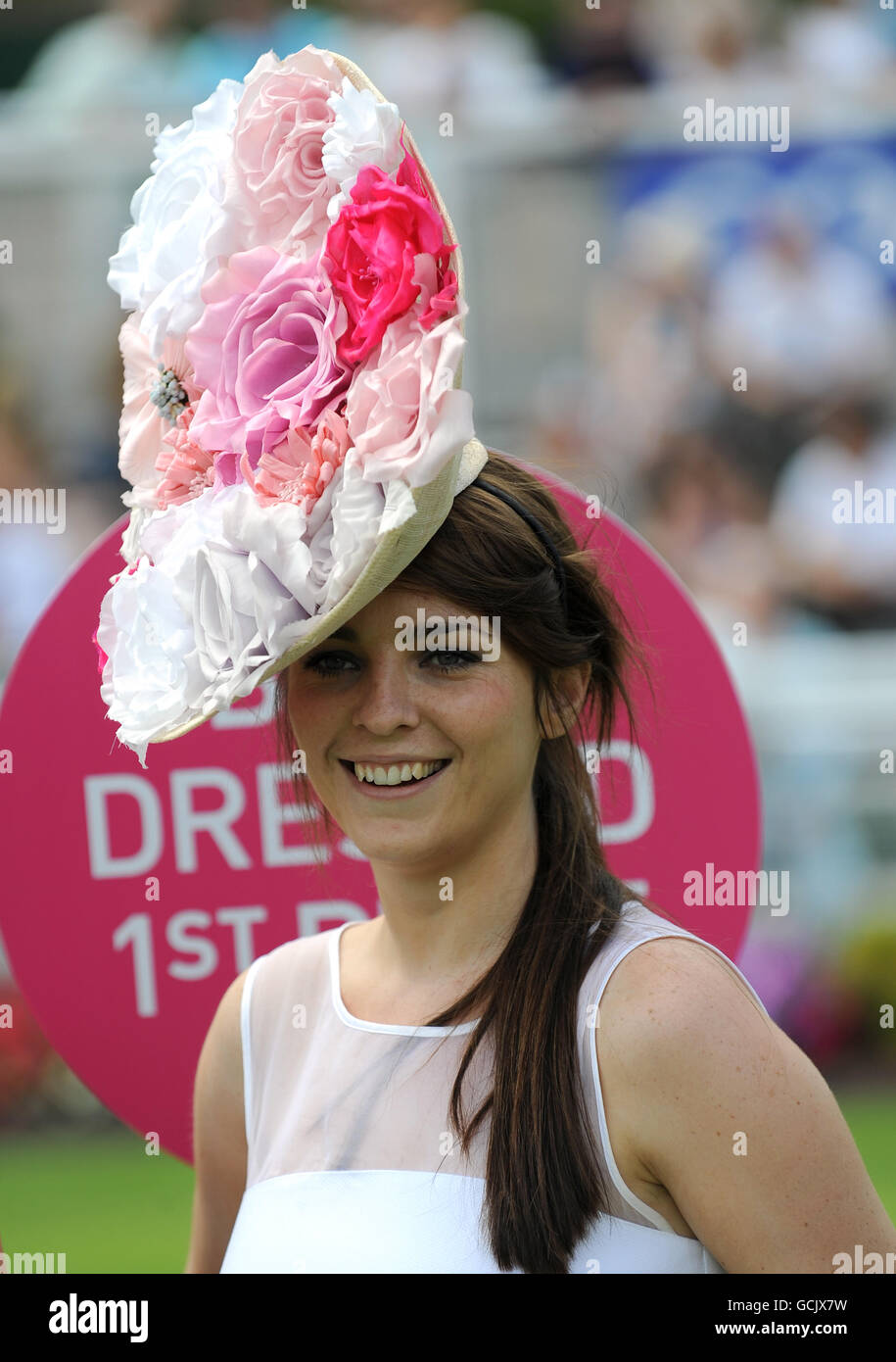 Racegoers take part in the Best Dressed Lady competition during the Coral-Eclipse Day at Sandown Park Stock Photo