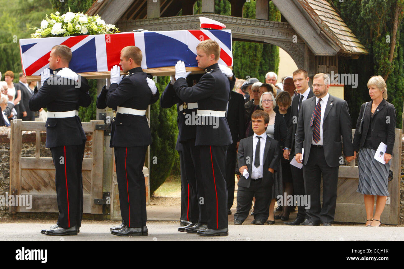 Parents Jenny and Robin Hollington (right) with sons Charlie (third from right) and Nick at the funeral of their third son Royal Marine Richard Hollington in the village of Steep in Hampshire. The 23 year old was the 300th soldier to die in the Afghanistan conflict. He passed away on Father's Day at Queen Elizabeth Hospital in Birmingham, eight days after being wounded on patrol in Sangin Province while serving with 40 Commando. Stock Photo