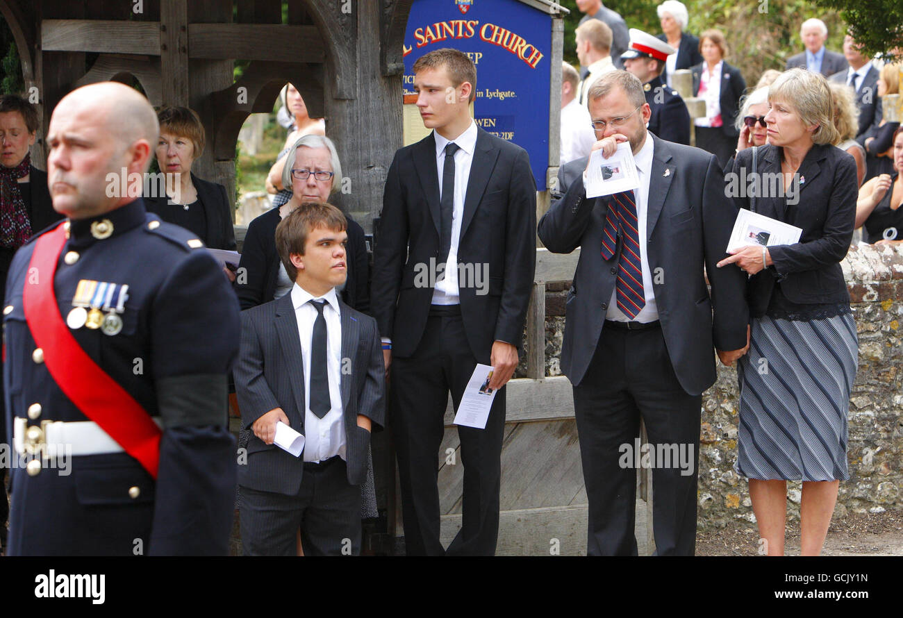 Parents Jenny and Robin Hollington (right) with sons Charlie (third from right) and Nick at the funeral of their third son Royal Marine Richard Hollington in the village of Steep in Hampshire. The 23 year old was the 300th soldier to die in the Afghanistan conflict. He passed away on Father's Day at Queen Elizabeth Hospital in Birmingham, eight days after being wounded on patrol in Sangin Province while serving with 40 Commando. Stock Photo