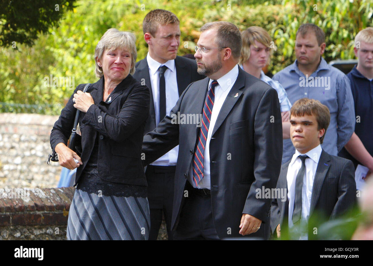 Parents Jenny and Robin Hollington (front) with sons Nick (right) and Charlie (back middle) at the funeral of their eldest son Royal Marine Richard Hollington in the village of Steep in Hampshire. The 23 year old was the 300th soldier to die in the Afghanistan conflict. He passed away on Father's Day at Queen Elizabeth Hospital in Birmingham, eight days after being wounded on patrol in Sangin Province while serving with 40 Commando. Stock Photo