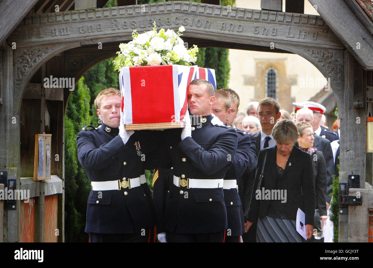 Jenny Hollington (right) and her son and Charlie follow the coffin of her eldest son, Royal Marine Richard Hollington, at his funeral in the village of Steep in Hampshire. The 23 year old was the 300th soldier to die in the Afghanistan conflict. He passed away on Father's Day at Queen Elizabeth Hospital in Birmingham, eight days after being wounded on patrol in Sangin Province while serving with 40 Commando. Stock Photo