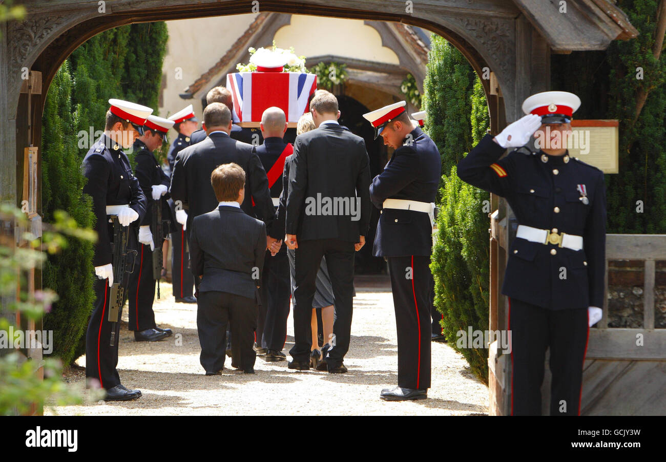 Parents Jenny and Robin Hollington with sons Nick (left) and Charlie follow the coffin of their eldest son, Royal Marine Richard Hollington, into All Saints Church in the village of Steep in Hampshire. The 23 year old was the 300th soldier to die in the Afghanistan conflict. He passed away on Father's Day at Queen Elizabeth Hospital in Birmingham, eight days after being wounded on patrol in Sangin Province while serving with 40 Commando. Stock Photo