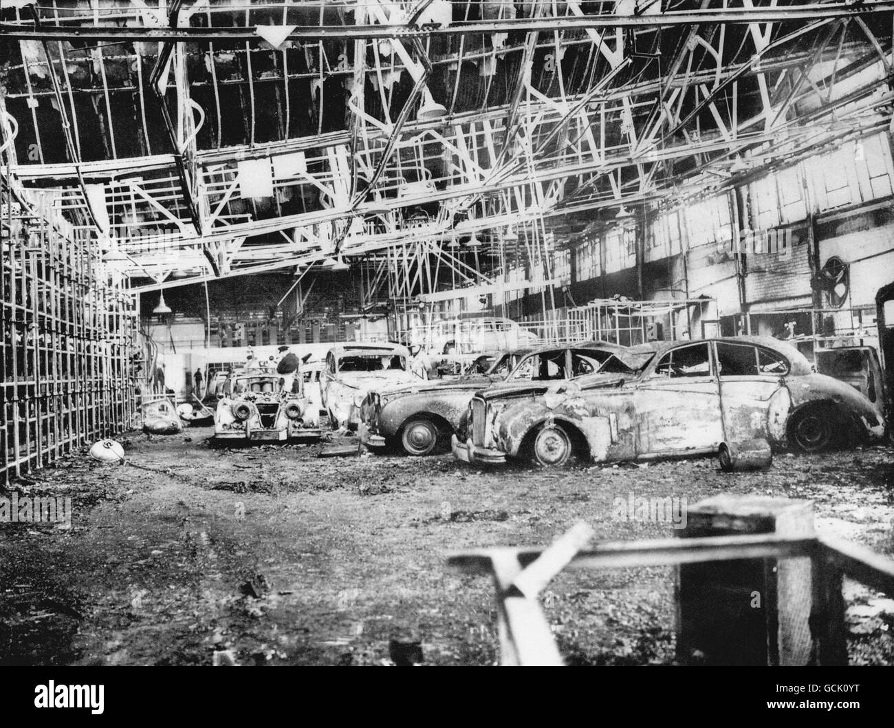 Jaguar Mk VIII's lay burnt and water-damaged after a fire swept through the car firm's Browns Lane Plant in Coventry during the night. Stock Photo